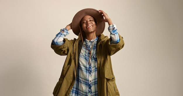 Pretty mixed race woman with short hair in autumn outwear and hat