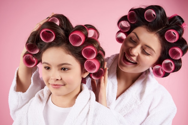 Pretty mother and daughter in hair curlers