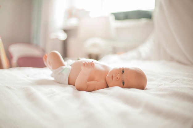 Pretty newborn baby lying on a light blanket