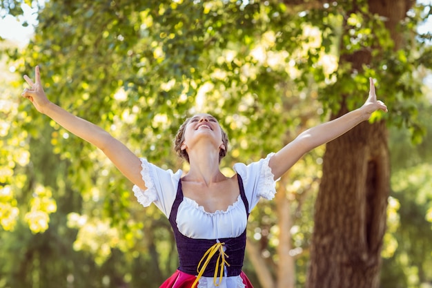 Pretty oktoberfest blonde feeling free in the park