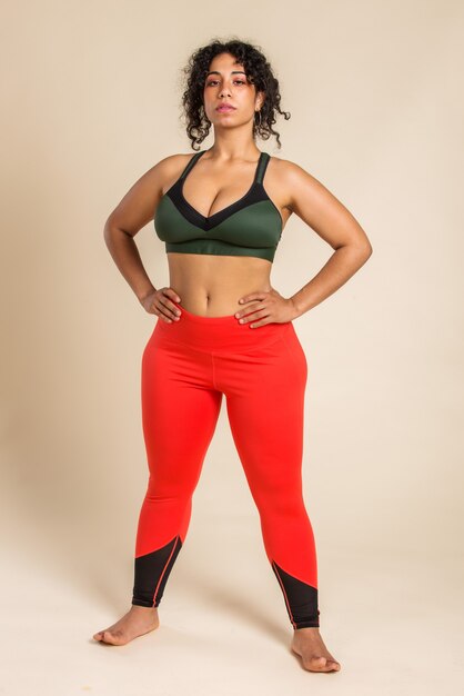 Pretty oversize woman wearing sportswear posing in studio