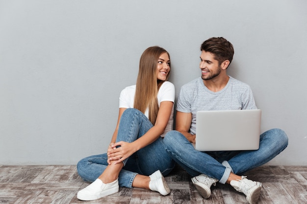 Pretty portrait of couple with laptop