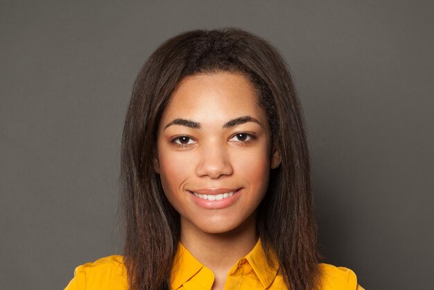 Pretty positive black woman smiling cute female face close up portrait