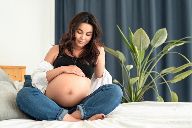 Pretty pregnant woman at home