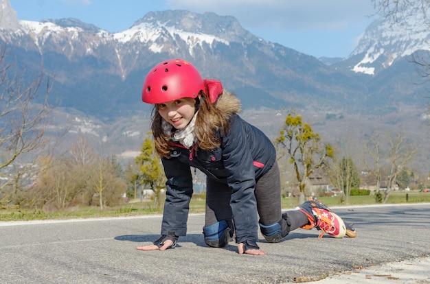 Pretty preteen girl on roller skates in helmet