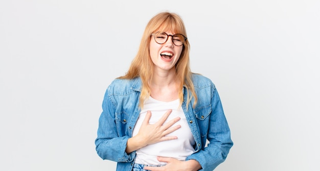 Pretty red head woman laughing out loud at some hilarious joke