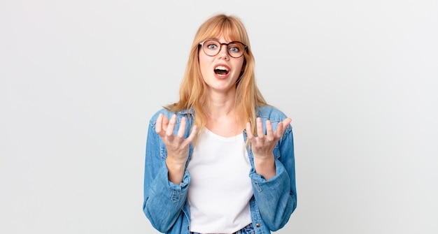 Pretty red head woman looking desperate, frustrated and stressed