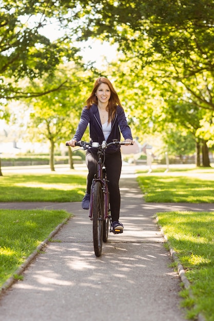 Pretty redhead cycling a bike