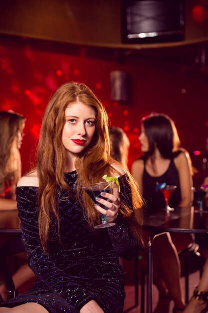 Pretty redhead drinking a cocktail 