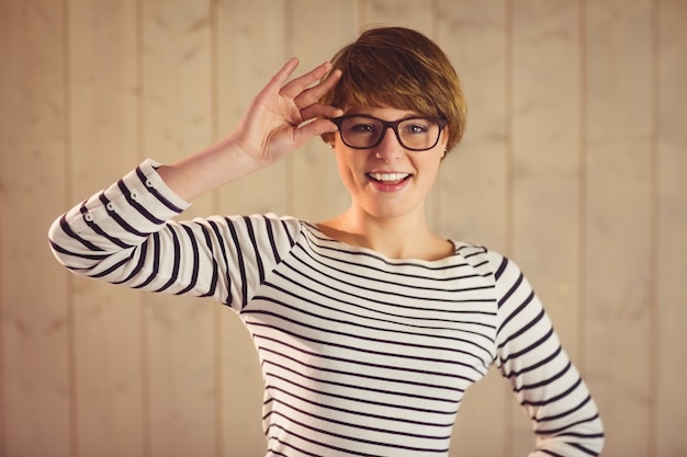 Pretty redhead holding her reading glasses