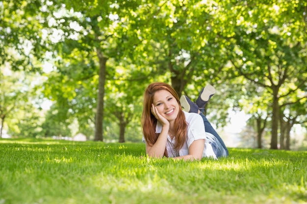 Pretty redhead relaxing in the park 