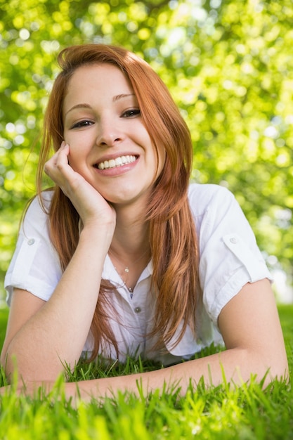 Pretty redhead relaxing in the park 