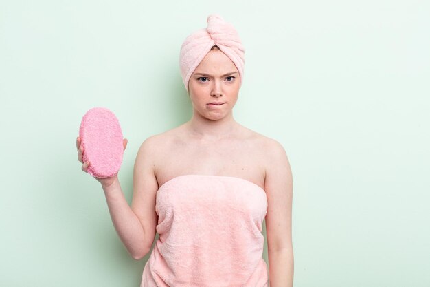 Pretty redhead woman having a shower concept