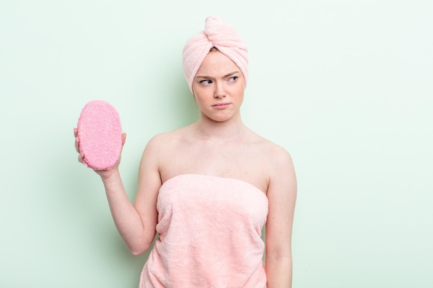 Pretty redhead woman having a shower concept