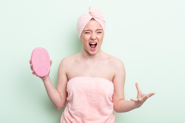 Pretty redhead woman having a shower concept