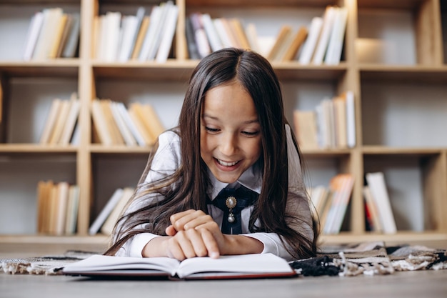 Premium Photo | Pretty school girl reading books at the library