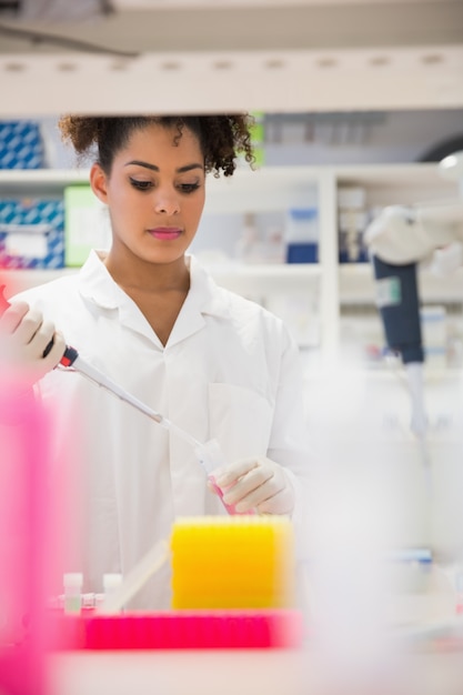 Pretty science student using pipette at the university