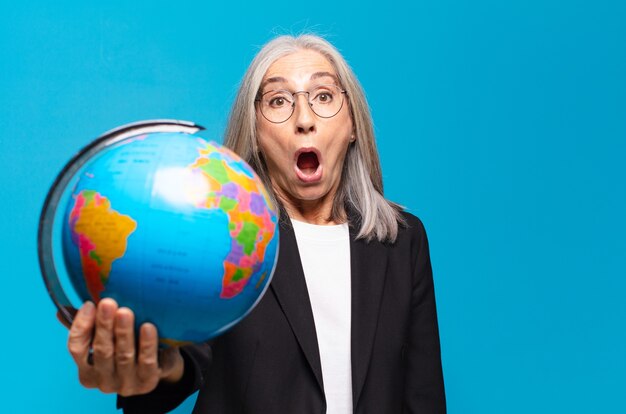 Pretty senior woman with a earth globe