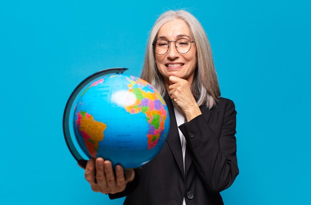 Pretty senior woman with a earth globe.