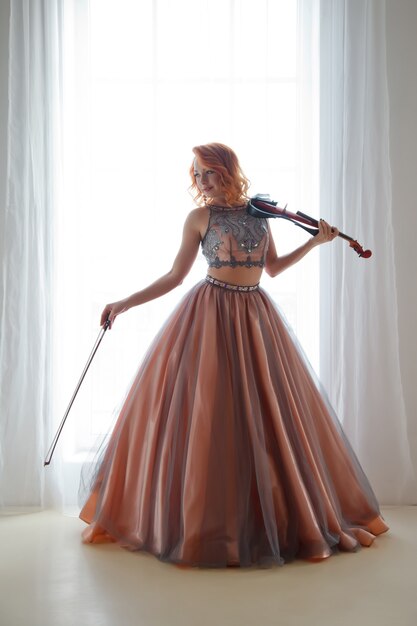 Pretty, slender woman with violin