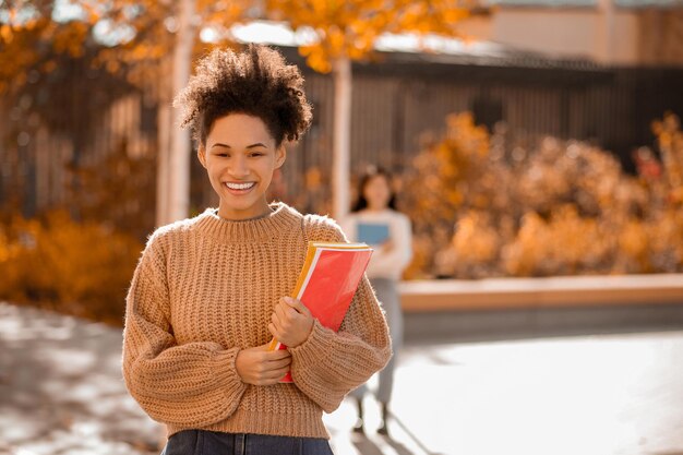 Pretty smiling mulatta in beige sweater