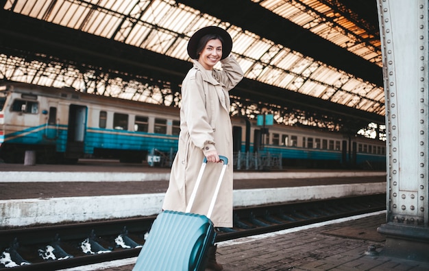 Pretty smiling woman at the railway station.