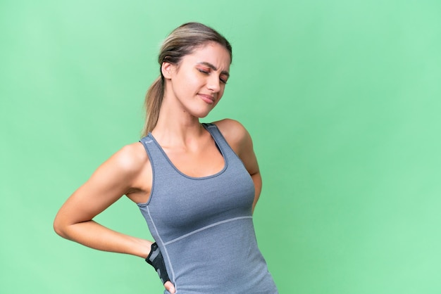 Pretty Sport Uruguayan woman over isolated background suffering from backache for having made an effort