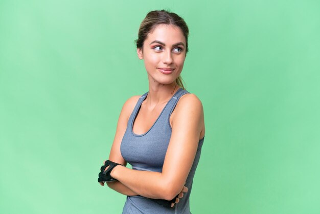 Pretty Sport Uruguayan woman over isolated background with arms crossed and happy