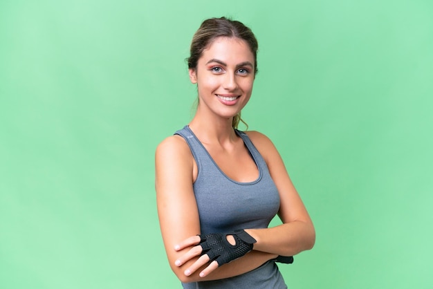 Pretty Sport Uruguayan woman over isolated background with arms crossed and looking forward