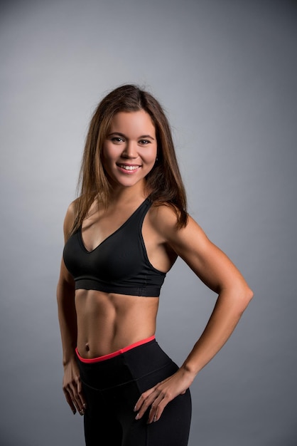 pretty sportswoman in black top and leggings