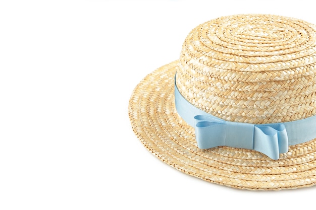 Pretty straw hat with blue ribbon isolated on white surface