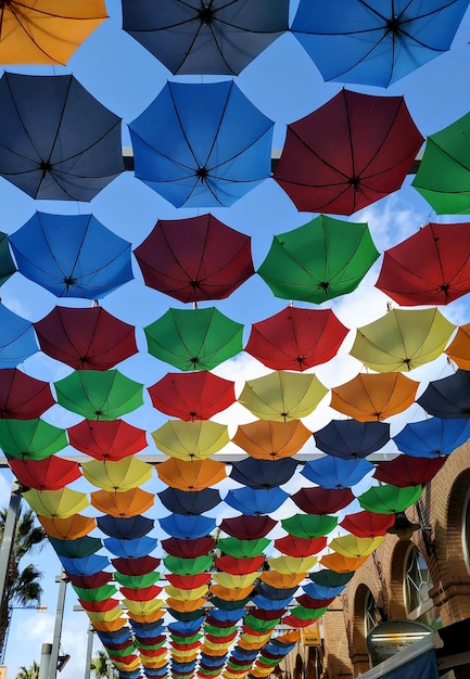 Pretty street lined with a multitude of colored umbrellas