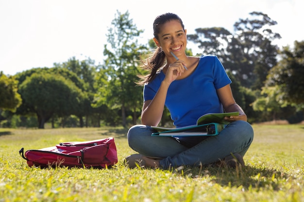 Pretty student studying outside