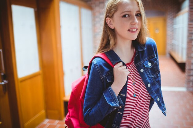 Pretty student with backpack looking at the camera