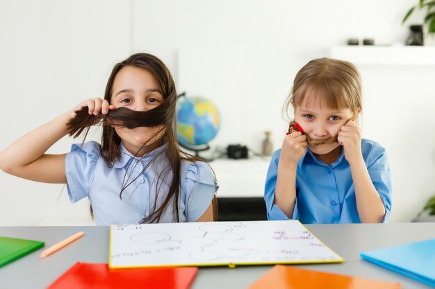 Pretty stylish schoolgirls studying during her online lesson at home, social distance during quarantine, self-isolation, online education concept