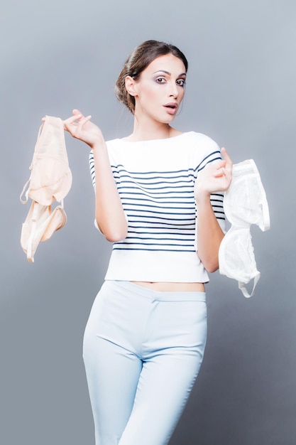 Pretty stylish woman with bra in studio