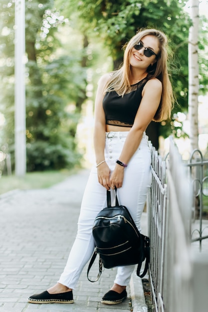 Pretty and stylish young girl in street photoshoot