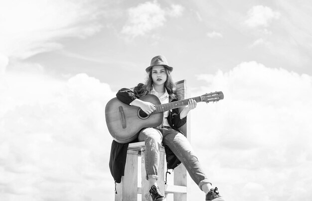 Pretty teen girl with acoustic guitar guitarist