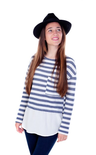 Pretty teenager girl with black hat posing at studio.