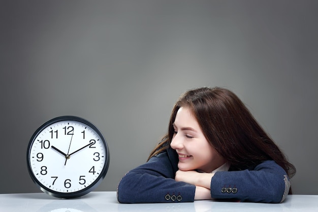 Pretty teenager looking at clock