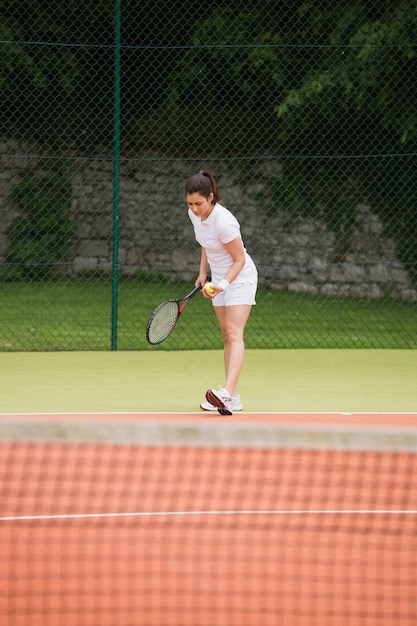 Pretty tennis player about to serve