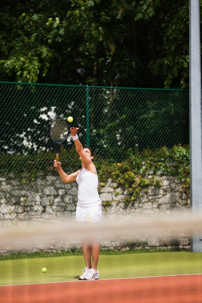 Pretty tennis player about to serve