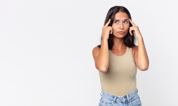 Pretty thin hispanic woman feeling confused or doubting, concentrating on an idea