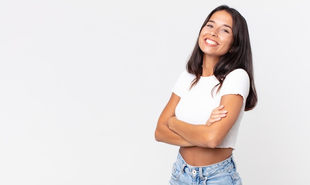 Pretty thin hispanic woman laughing happily with arms crossed