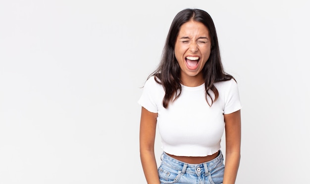 pretty thin hispanic woman shouting aggressively, looking very angry