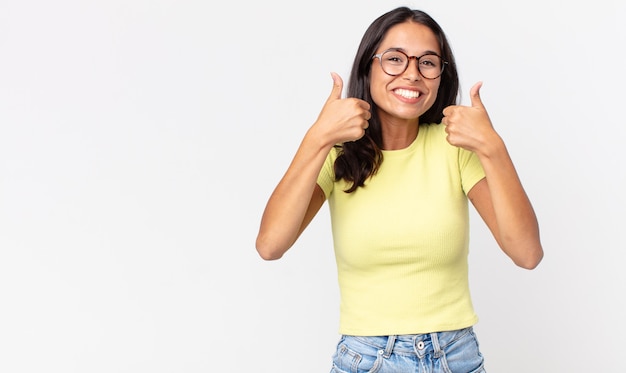 Pretty thin hispanic woman smiling broadly looking happy