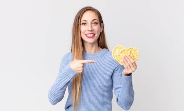 Pretty thin woman holding a rice diet cakes