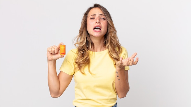 Pretty thin woman looking desperate, frustrated and stressed and holding batteries