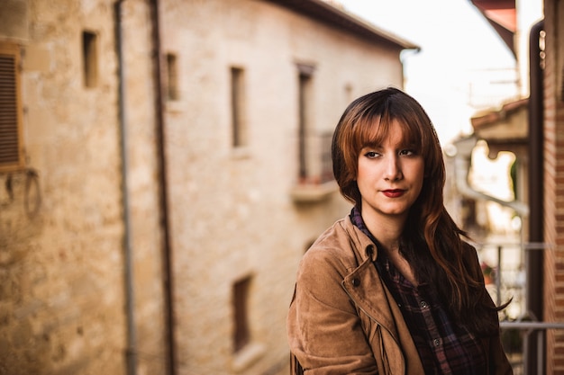 Pretty thoughtful young woman on the balcony in an ancient city