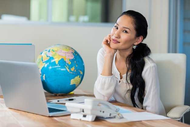 Pretty travel agent smiling at camera